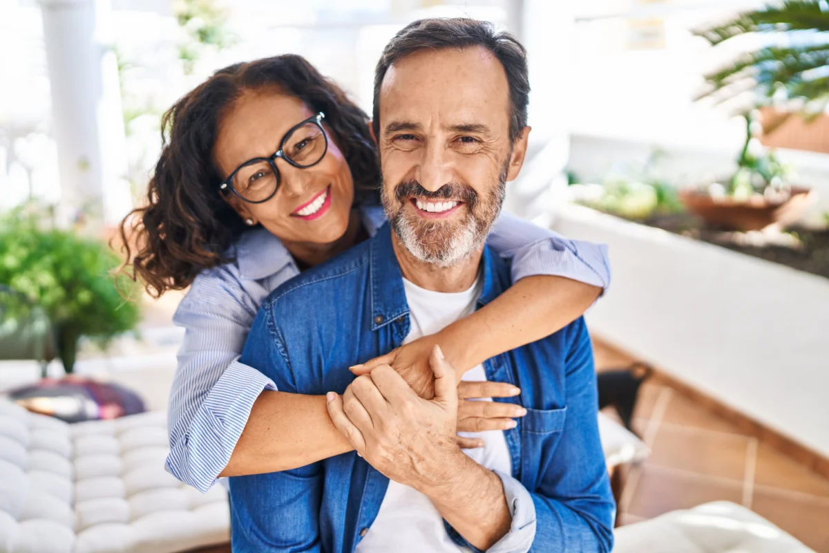 Happy senior couple smiling during wellness consultation in Wakefield, MA | Infinite Beauty Med Spa